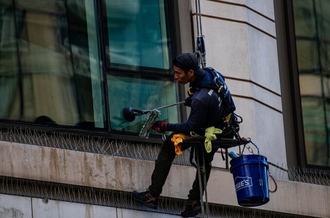 a cleaner wearing safety harness